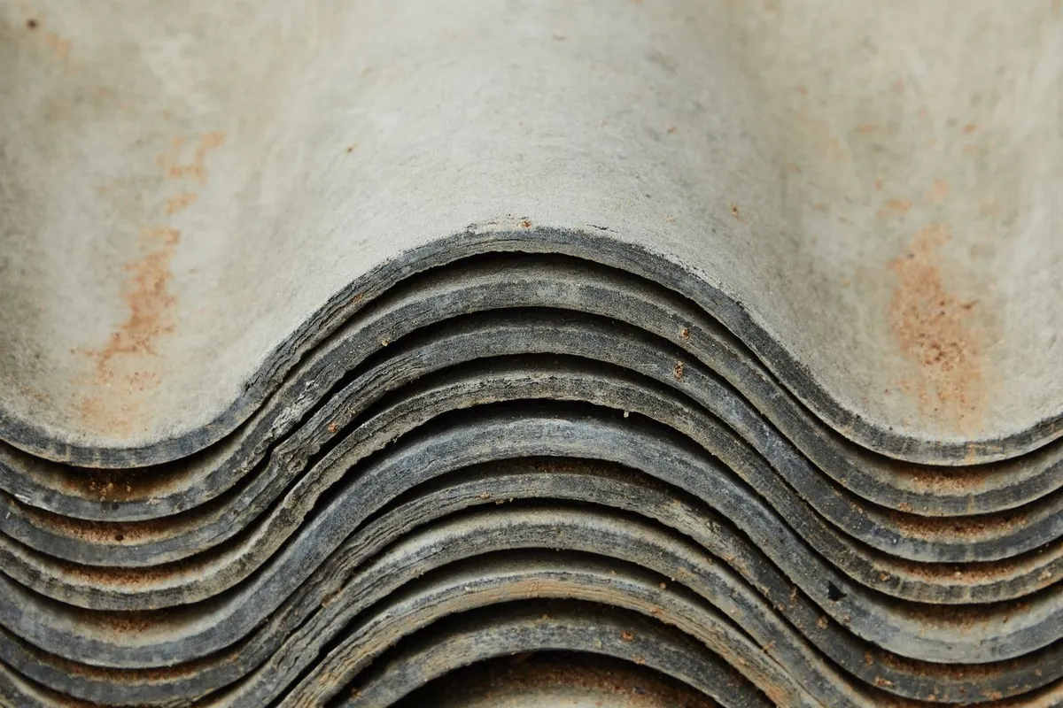 A pile of worn slate tiles, highlighting the importance of quality materials for roof installation.