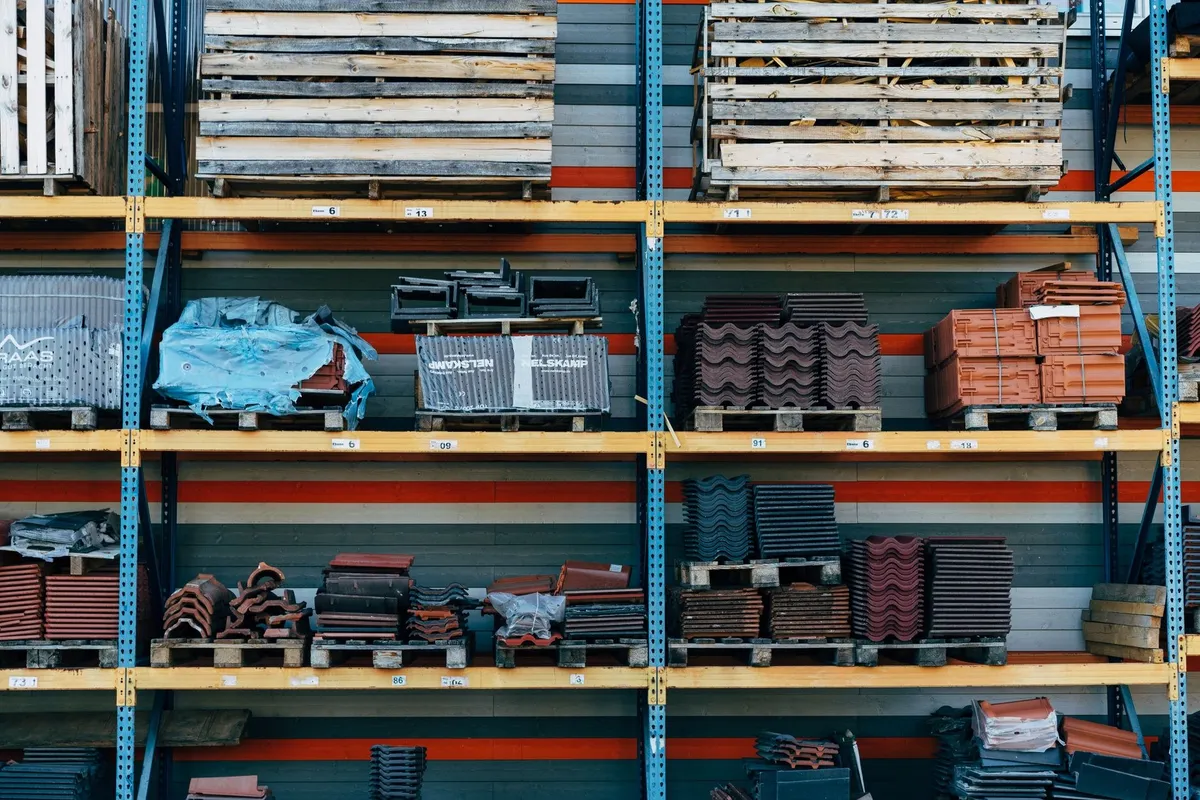 Shelves filled with various construction materials, highlighting the importance of material choice in roofing.